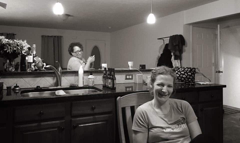 Two women, who live in a mommune, share a laugh. 