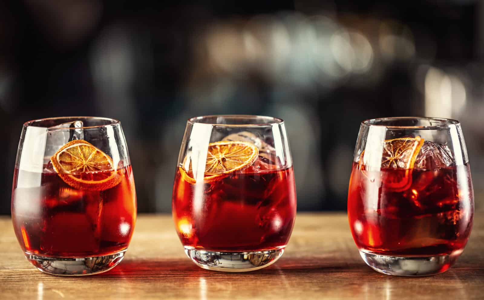 bourbon, Campari, and sweet vermouth drink garnished with an orange slice