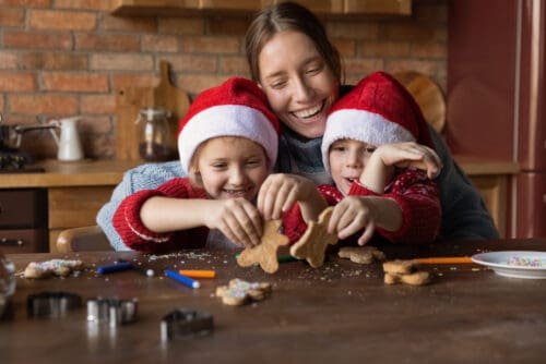 A single mom making holiday cookies with her children