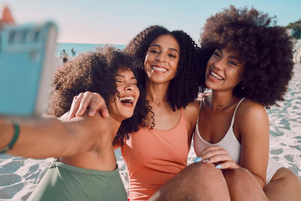 Summer selfie, beach and black women friends enjoy holiday, vacation and weekend travel together.