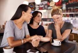 Friends, coffee and sad woman in cafe for support in mental health, counselling and help for stress.