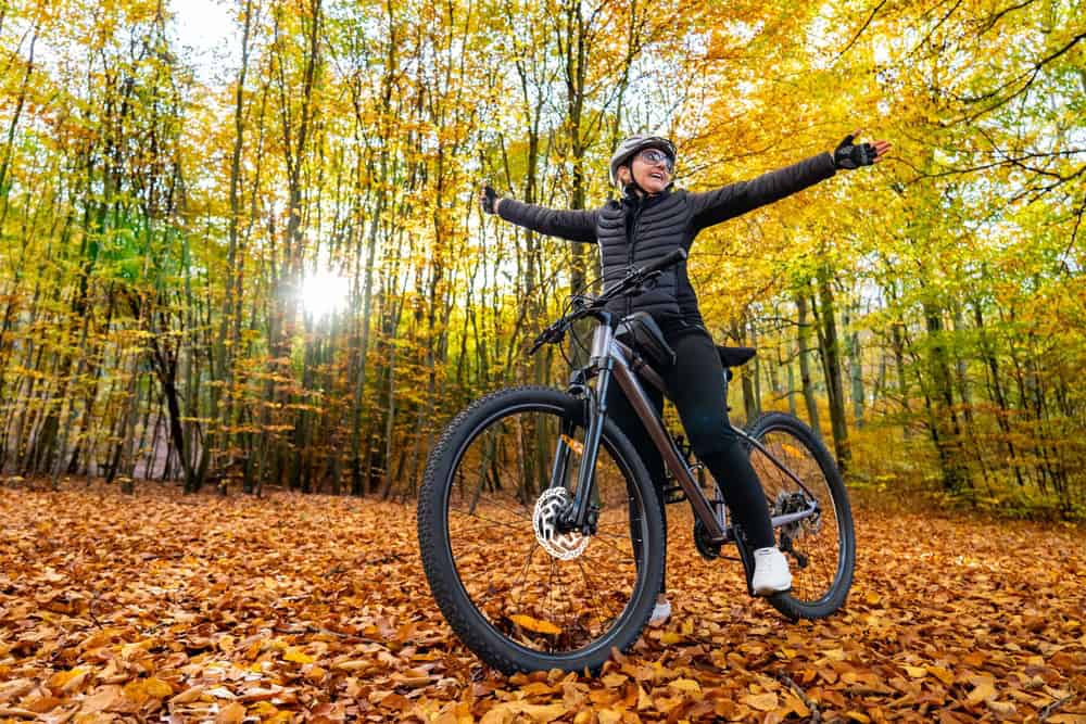 Women riding a bike during fall